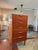 A mid century modern tallboy in teak by Austinsuite, circa 1960s. It features six drawers with contoured handles and...