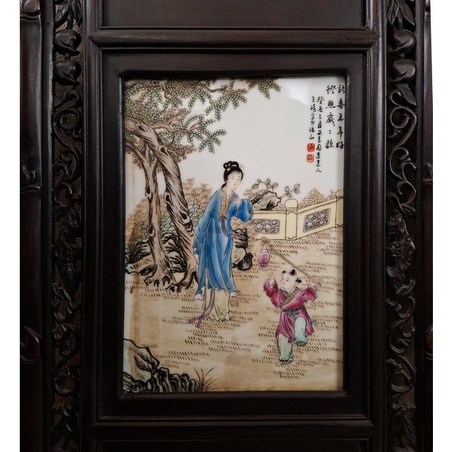 Set of four, large, Chinese, reticulated, hongmu frames, each with mountings of three porcelain plaques, a fan shape, a...