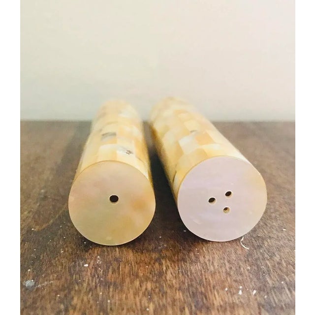 Set of mother of pearl salt & pepper shakers. Each piece of mother of pearl has been meticulously set together like gems...