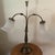 The Vintage Double Arm Brass Table Lamp with a fruited base and bell-shaped glass shades is a charming and unique lighting...
