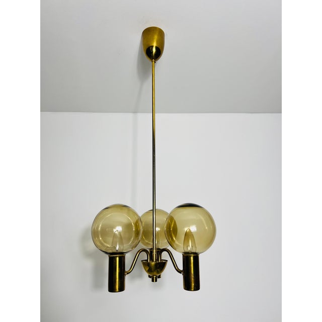 This exquisite brass and glass chandelier, designed by the renowned swedish designer hans-agne jakobsson in the 1960s, is...