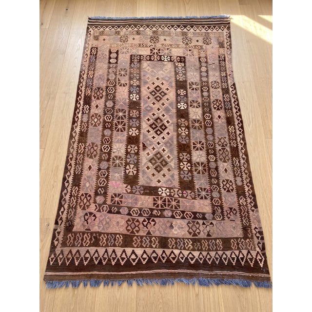 Handwoven from sheep’s wool, this vintage Afghan kilim carries the quiet beauty of a piece made slowly by skilled hands....