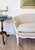 An elegant Louis XV-style painted canapé featuring a gracefully shaped serpentine frame, flowing cabriole legs, and a...