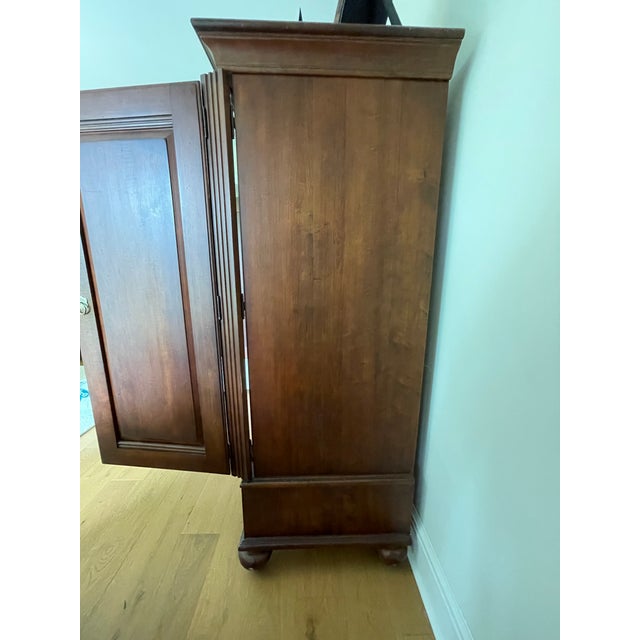 Raised panel doors, edged in ribbed trim and bun feet. The interior is functionally equipped with a TV punch-out, a deep...