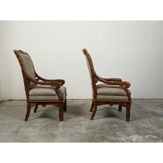 A set of eight Black Forest dining room chairs from the early 20th century, with carved foliage décor and upholstery....