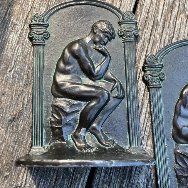 2 steel bookends that have a bronze colored finish 5 inches high 3 wide 2 deep (heavy for size)