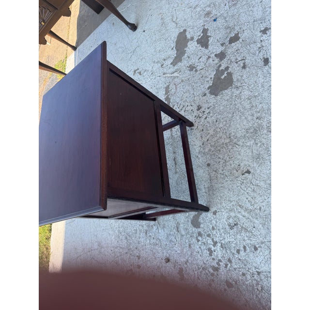 Vintage smoking stand / side table featuring a rectangular wooden top, hinged drop-front cabinet door, brass hardware, and...