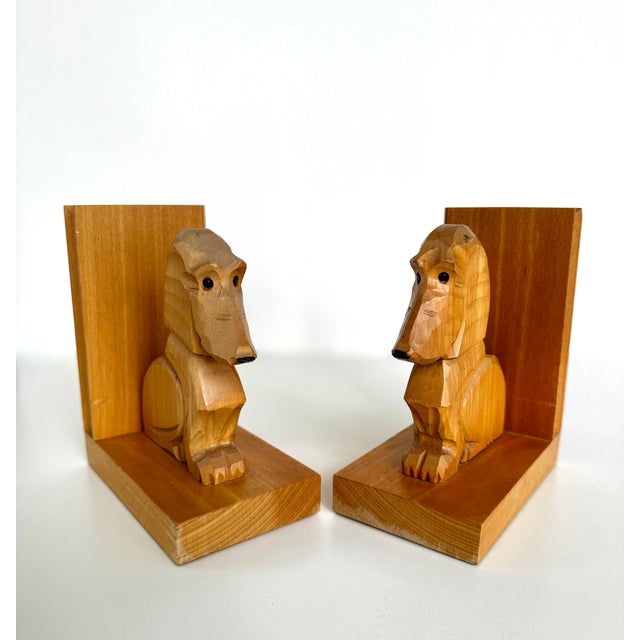 Pair of wooden hand crafted bookends by Dobin, Switzerland. Each piece is carved in the shape of a dachshund or basset...