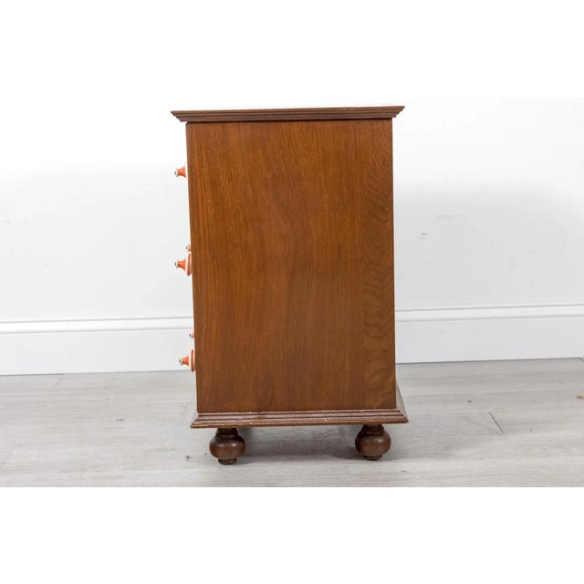 A Danish style mid-century four drawer nightstand or small side table with lively pulls and solid dovetailed joinery....