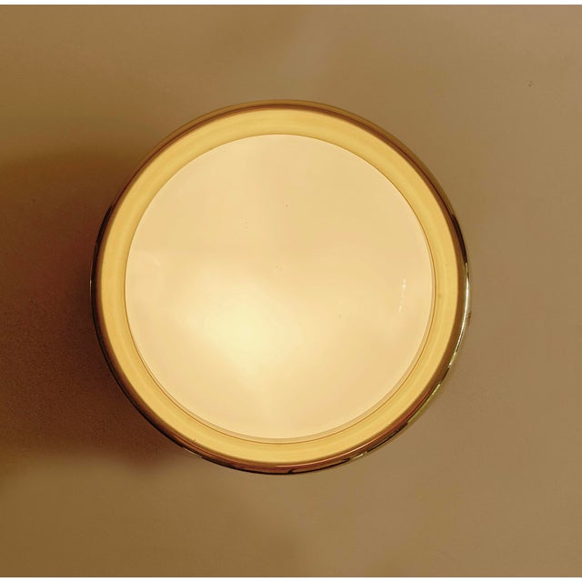 Vintage Limburg sconce or ceiling light, to be embedded, circular casing with a brass frame, opaline glass insert, the...