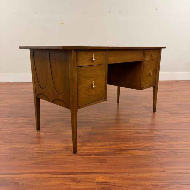 Broyhill Brasilia walnut desk with finished back and cane privacy screen, made in the U.S. in 1965. This iconic mid-...