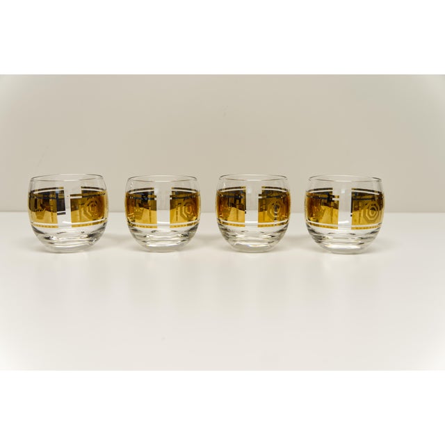 A set of four roly-poly–shaped lowball rocks glasses, attributed to Vito Bari. Each glass features an elegant gold band...
