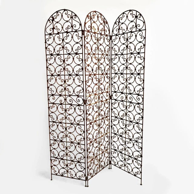 Vintage free standing rusted finish iron three panel folding screen. Beautiful traditional scroll design. Great used...