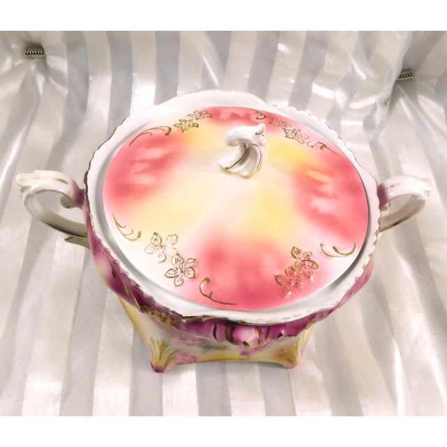 This is a Reinhold Schlegelmilch RS Prussia footed covered biscuit jar in pink and yellow. This item has a close, but not...