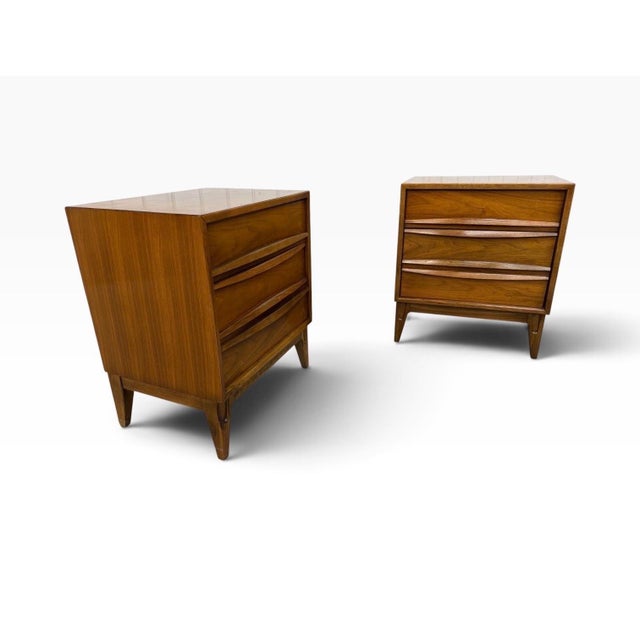 A handsome pair of Mid-Century Modern 3-Drawer Walnut Nightstands, American made and dating to the 1960s. Each nightstand...