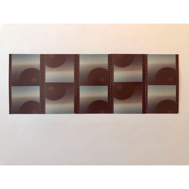 This one depicts an abstract assemblage of film strip (still or movie film) edges in a pattern and decoration style. It is...