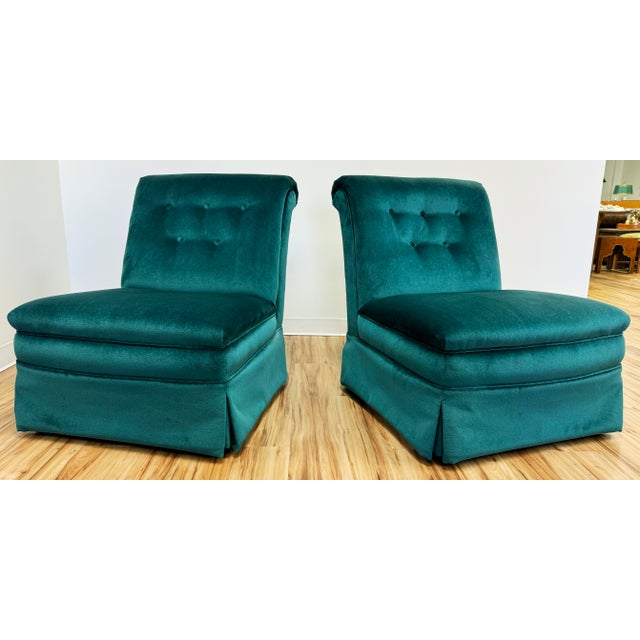 Vintage pair of deep teal velvet slipper chairs featuring tufted backs and matching piped back rest cushions. These are a...