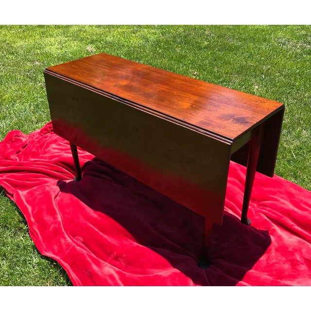 This beautiful Georgian table has a very nice butterscotch color. It has twin drop leaves with gateleg supports. It sits...