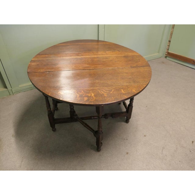 Georgian Oak Gate Leg Table with drawer The table has a solid oak top with turned legs, the table is in good condition for...