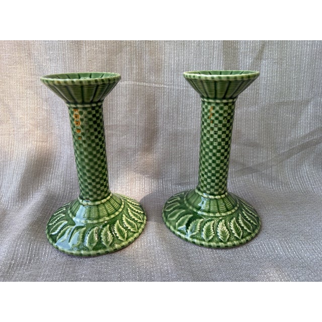A lovely pair of green ceramic basketweave candlesticks with a leaf design around the base. Bordallo Pinheiro, stamped on...