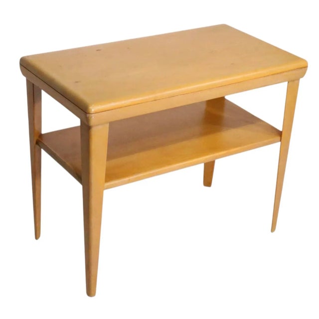 Classic Mid Century two tier side table, by Heywood Wakefield in good original condition. This example is in Champagne...
