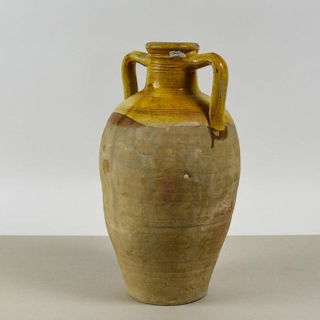 This imposing amphora vase, likely dating back to the 19th or 20th century and originating from the rural italian artisan...