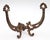 Antique Victorian style hall tree hook made of cast iron with brass plating. There is a screw attached to the back with a...