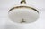 A Mid-Century Modern brass and plastic pendant light. The light has a rounded and patterned plastic shade in a waffle...