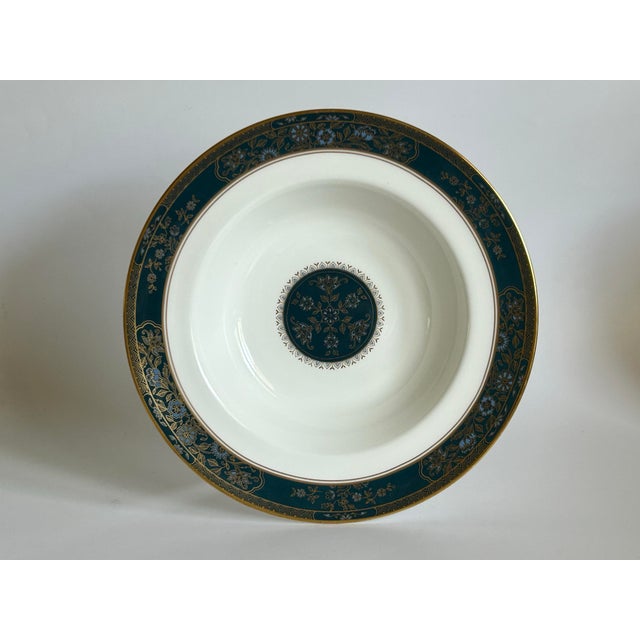 A refined English bone china pattern by Royal Doulton, Carlyle (H5018), featuring a deep teal-blue border with delicate...