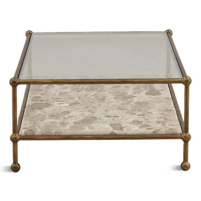 Strikingly sophisticated with an organic character, this Tendu marble shelf coffee table has a slender iron frame in an...