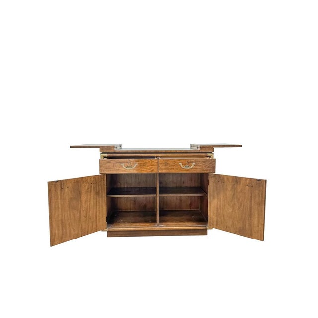 This vintage Drexel Heritage sideboard is a beautifully crafted example of Mid-Century Modern design with strong Campaign-...