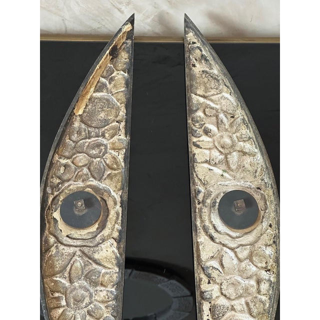 A stunning pair of solid bronze ornaments dating from the Art Deco period, featuring a delicate floral motif in relief,...