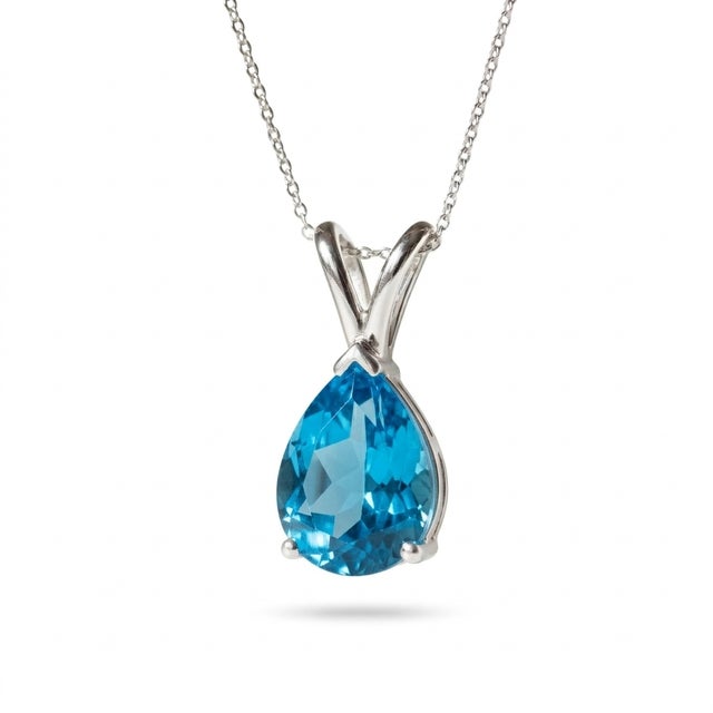 This elegant pendant features a captivating Blue Topaz gemstone, admired for its vivid ocean-blue hue and brilliant...