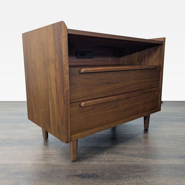 The nightstand has a 1960s-inspired mid-century design with a tailored profile and streamlined shape. Crafted of solid...