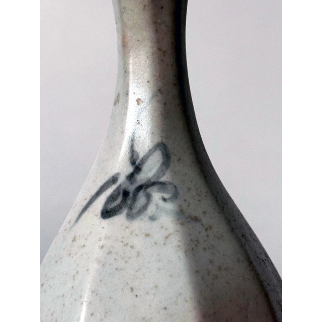 A Korean blue and white long neck vase in bottle form with octagonal faceted surface from late Joseon Dynasty (18th-...