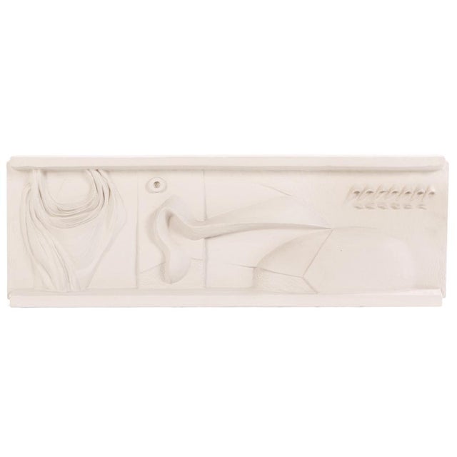A mid-century modern abstract bas-relief wall hanging sculpture, circa 1960s, executed in painted fiberglass. The...