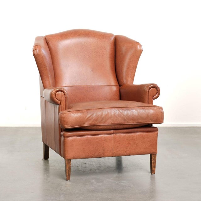 Offered by ByThijs: this light cognac-colored cowhide wing armchair with a characterful English look and excellent seating...