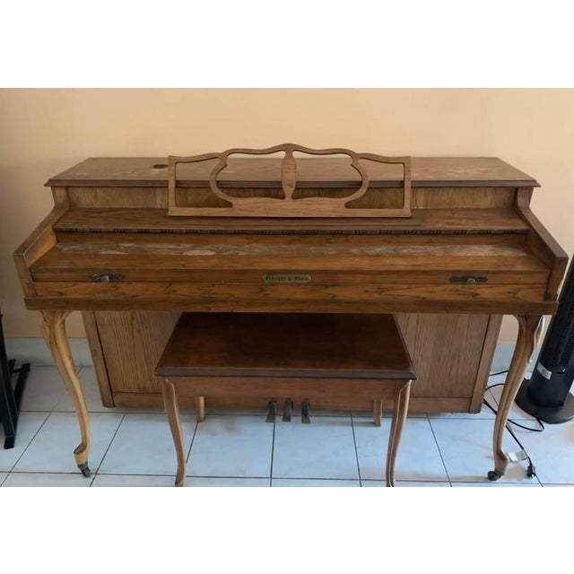 The Schafer & Sons Brown Wooden Piano is a vintage upright piano manufactured in 2000, featuring 88 keys made of mahogany...