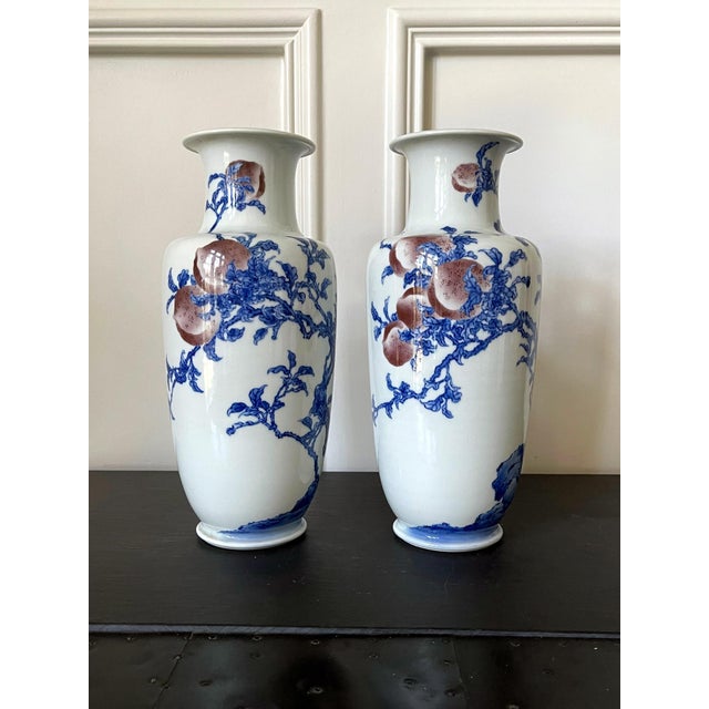 A pair of porcelain vases in classic form, decorated with underglaze blue and copper red painting by Imperial potter...
