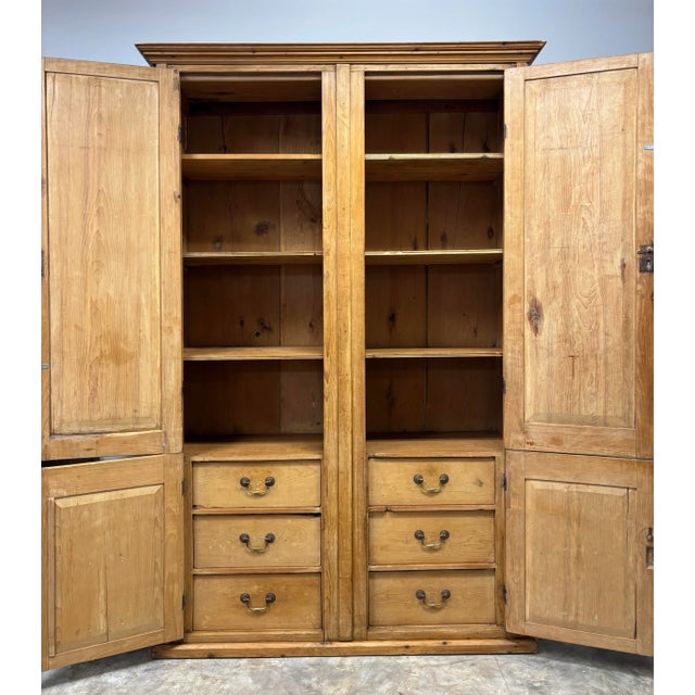 A beautiful example of early domestic craftsmanship, this Georgian era English pine housekeeper’s cupboard carries with it...