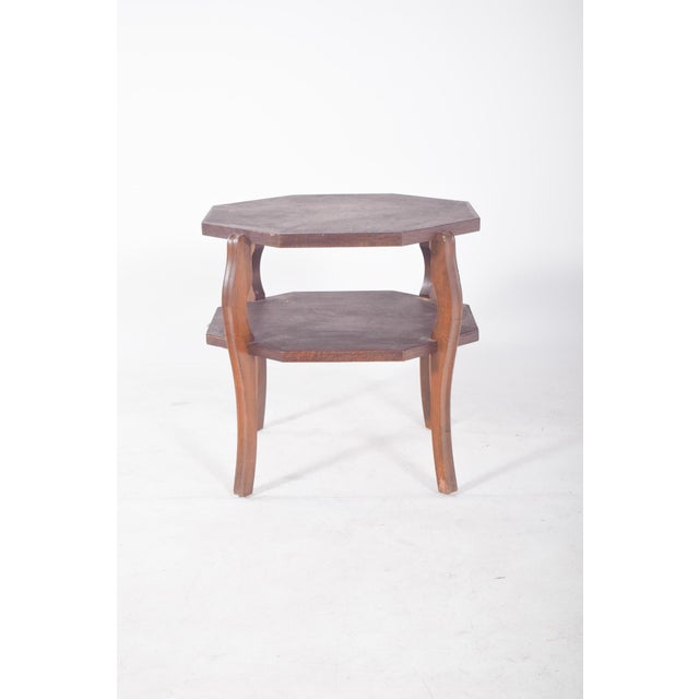Oak coffee table. With an octagonal design and a dark finish, it has two shelves, top and bottom, ideal for supporting...