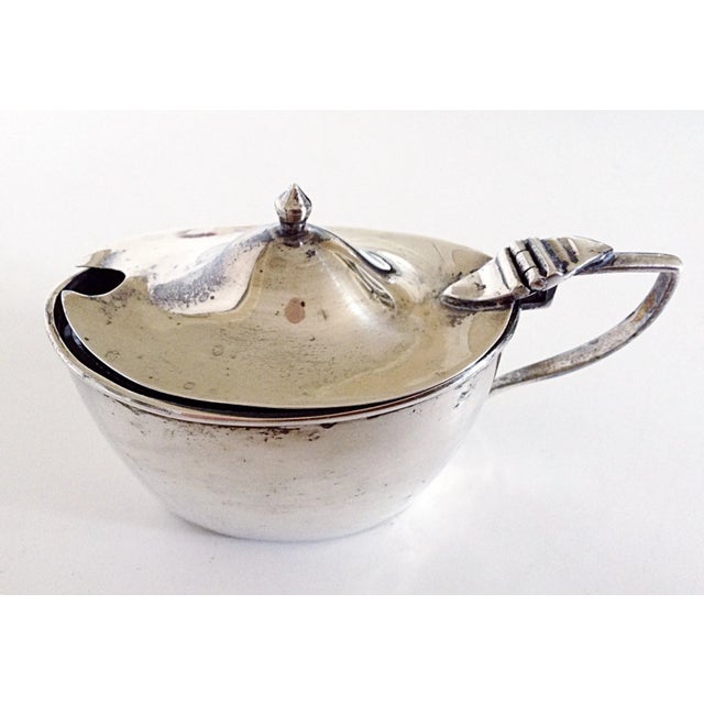 This English sterling mustard pot has its original cobalt blue glass liner. Markings are on the bottom of the piece as...