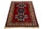 This Kazak wool rug is meticulously handcrafted and features a rich red palette adorned with delicate embellishments in...