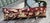 A beautiful pillow upholstered in 18th-century tapestry, featuring an elegant deep red ground adorned with richly detailed...