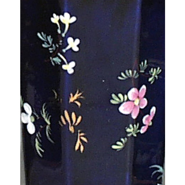 Mason's Ironstone Mazarine Blue Garniture of Three Vases, Polychrome Flowers Circa 1820–1830 A garniture of three Mason's...