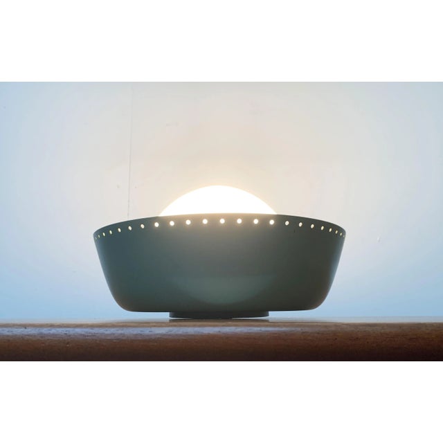 Mid Century ceiling light by Bega. A sober design in a minimalist language of form. The diffuser made of opal glass sits...