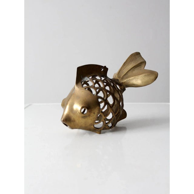 This mid-20th-century brass fish figure features a whimsical and imaginative design. The openwork body, fashioned to...