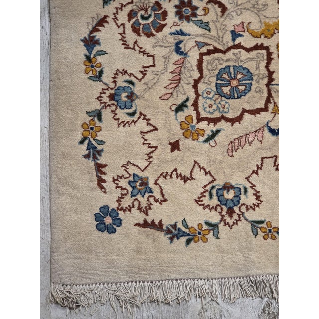 VintagePersian Kashan rug featuring an elegant ivory and cream field adorned with intricate floral motifs in dusty blue,...