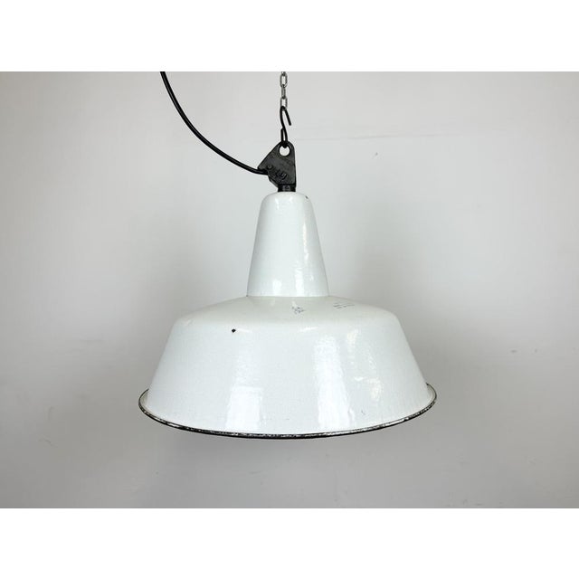 Industrial white enamel pendant light made by Zaos in Poland during the 1960s. White enamel inside the shade. Cast iron...