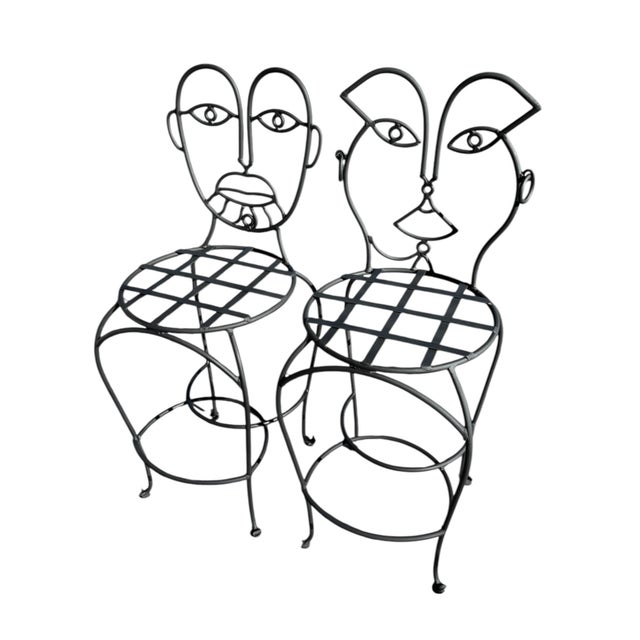 These wrought iron metal chairs are an inspired testament to the iconic works of the late John Risley, a celebrated...